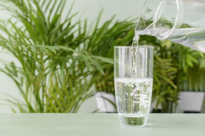 pouring water from a pitcher into a glass